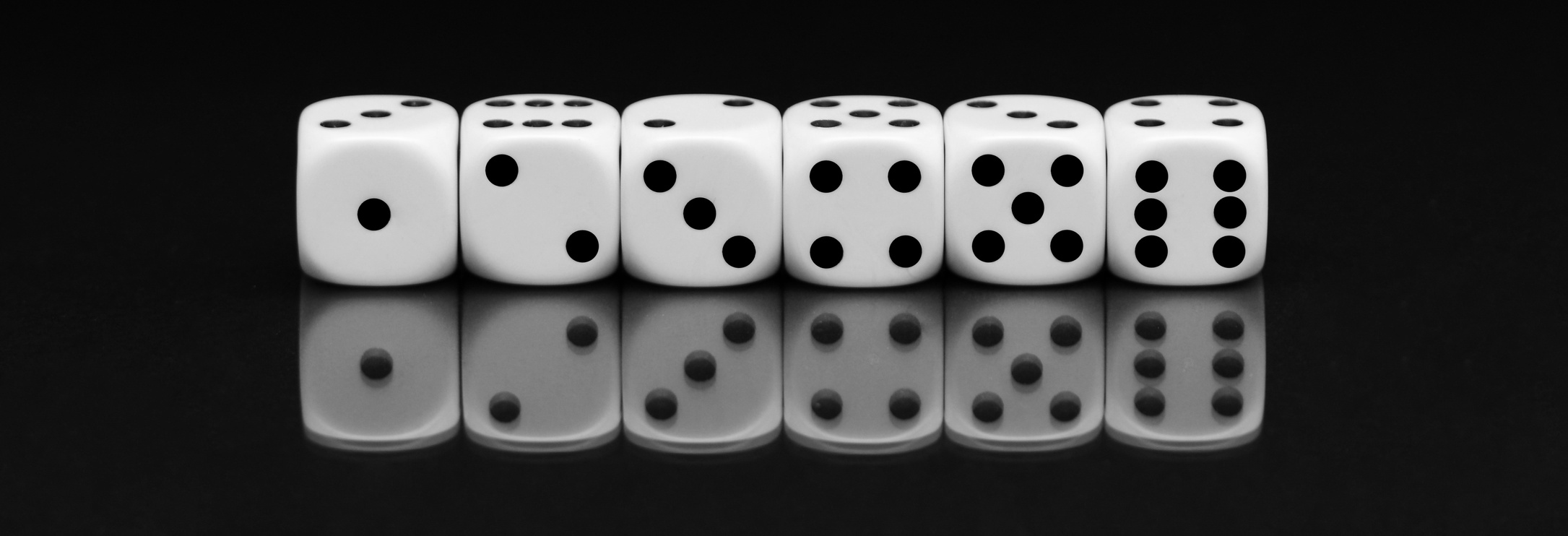 Dices on Black Background with Reflection
